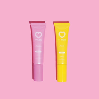Twee tubes Muski intieme musk: Seduction (witte musk) en Passion (monoï) op roze achtergrond.