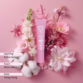 Muski Seduction intieme musk tube omringd door roze bloemen, katoenbloemen en ylang-ylang.